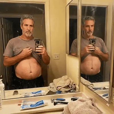 Gary looking at himself in the bathroom mirror